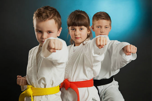 three kids performing a karate stance