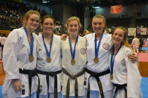 5 karate students wearing medals