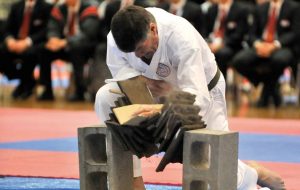 a karate student smashing wood