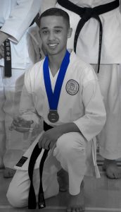 a karate student wearing a blue medal