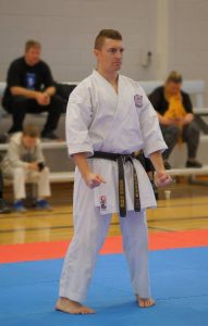 a karate student wearing a brown belt