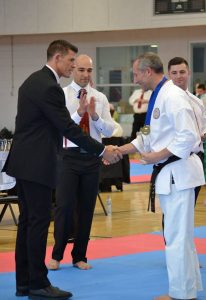 a karate participant receives an award