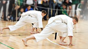 two karate students stretching