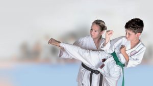 GKR Karate, Sensei, Instructor, helping student, Karate Kick