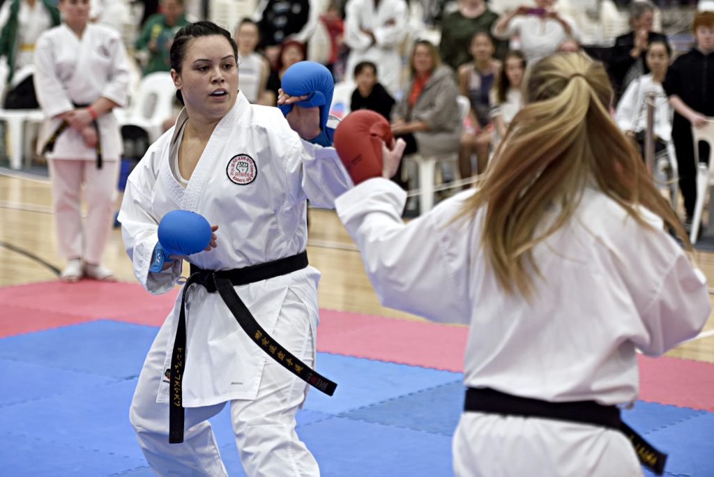 improving your style of kumite. two young girls performing kumite