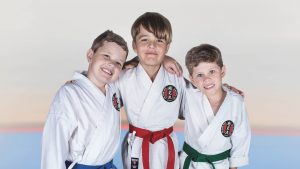 three young boys wearing gkr karate gi, posing in front of the camera