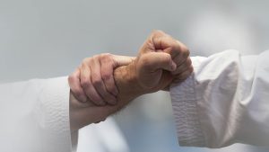 a karate student blocks another student