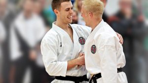two men shaking hands wearing gkr karate gis