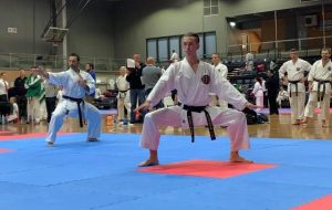 karate students performing moves in front of other students