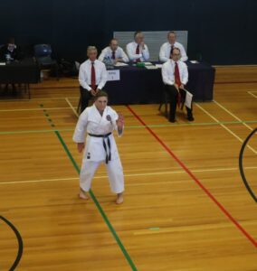 judges watch a karate competitor