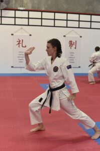 a young female performs a karate stance