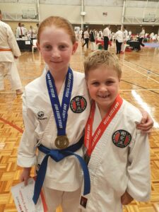 two young karate students with medals