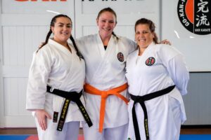 Three karateka after a karate grading