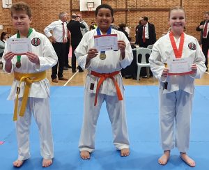 three young boys holding up there certificate of appreciation from gkr karate