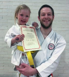 sensei mike norton holding his daughter