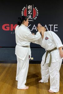 Sensei Charmaine demonstrating a move on a fellow karate-ka