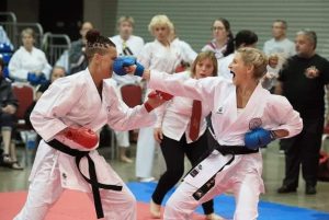 Sensei Dee punching a competitor at a tournament. international women's day 2022