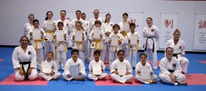 students posing in front of the camera after achieving there gradings