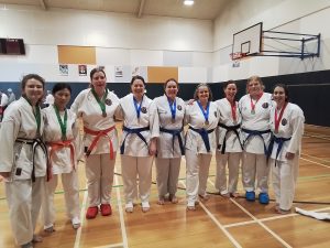a group of karate students celebrating with there medals