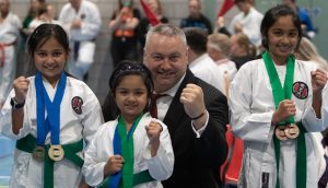a referee and a young karate student