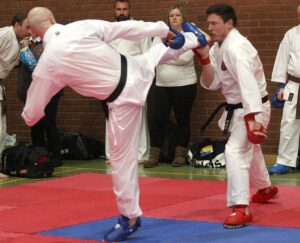 two black belt karate competitors are fighting